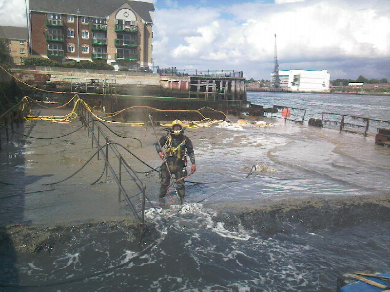 Seawork commercial diver working at a tidal dockside